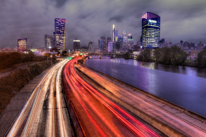 Long exposure of Philadelphia cityscape with traffic on highway
