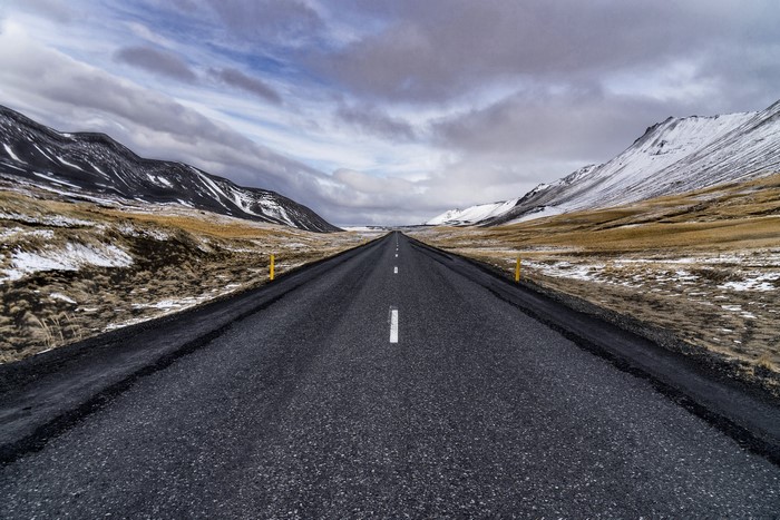 Asphalt road through a snowy landscape