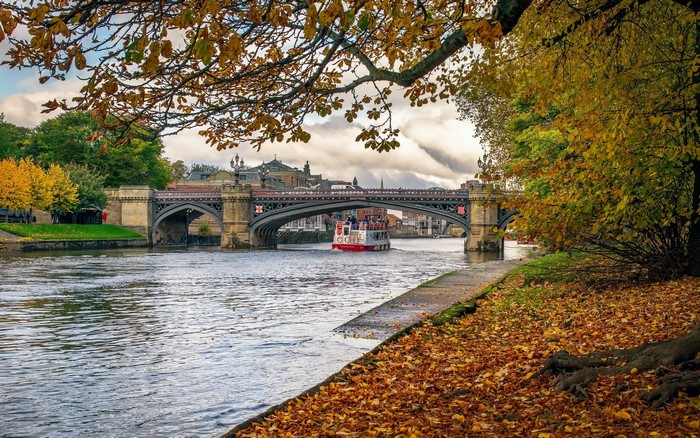 River with bridge and boat in autumn
