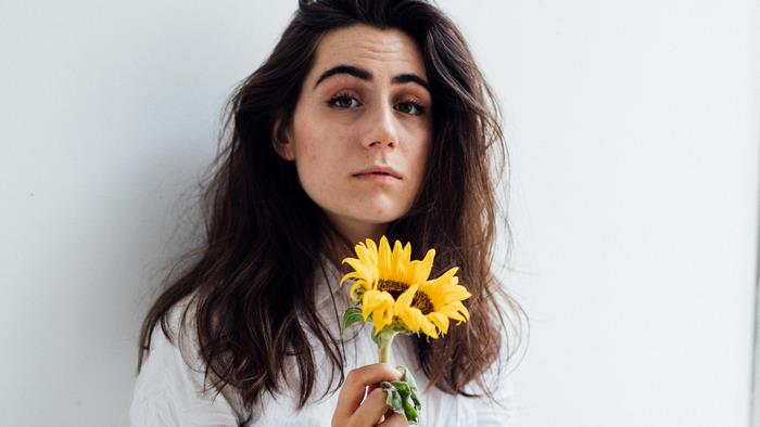 Dodie holding sunflowers