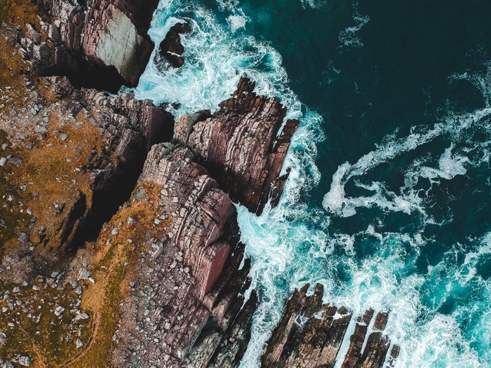 Aerial view of rocky coastline and blue sea