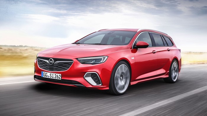 Red Opel Insignia Sports Tourer driving on a road