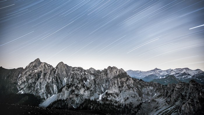 Star trails over snow-capped mountains