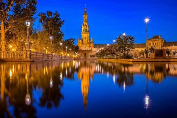 Plaza de España in Seville, Spain at dusk with reflections