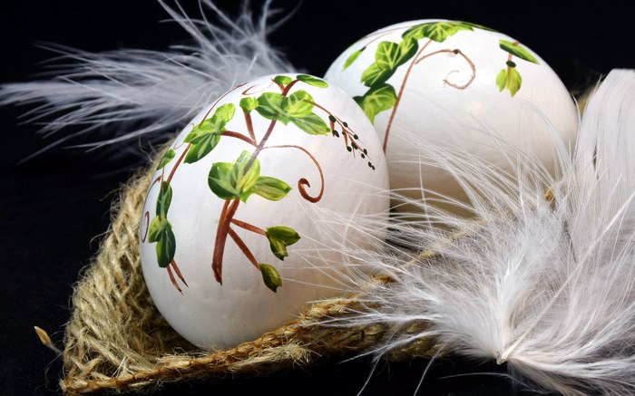 Decorated Easter eggs with floral design and feathers