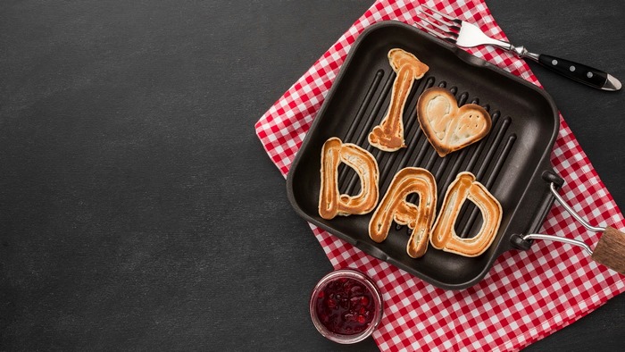 Pancakes spelling 'I Love Dad' in a grill pan