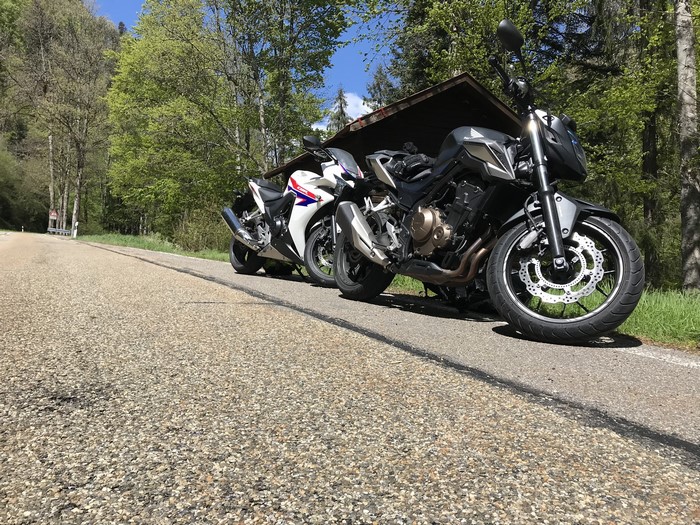 Two Honda motorcycles parked on a road
