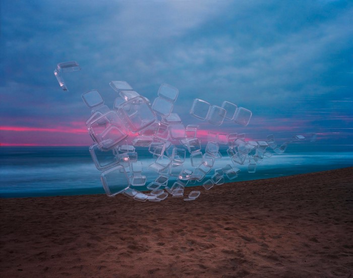 Thomas Jackson art installation of plastic cubes on a beach at sunset