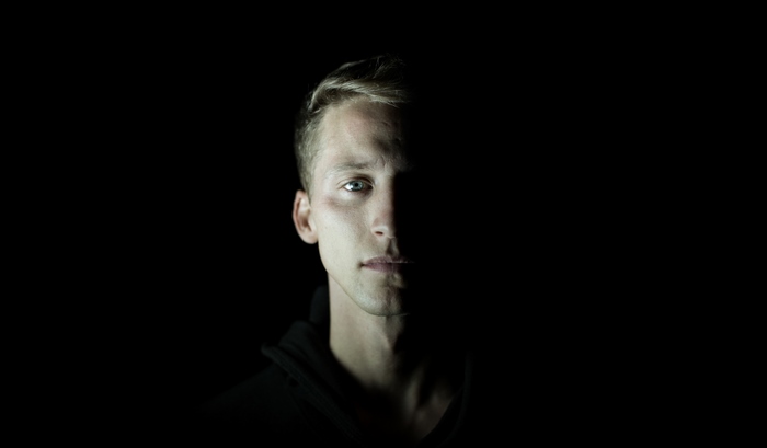 Man's face half in shadow