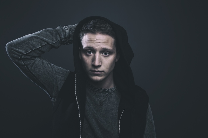Rapper NF wearing a hoodie