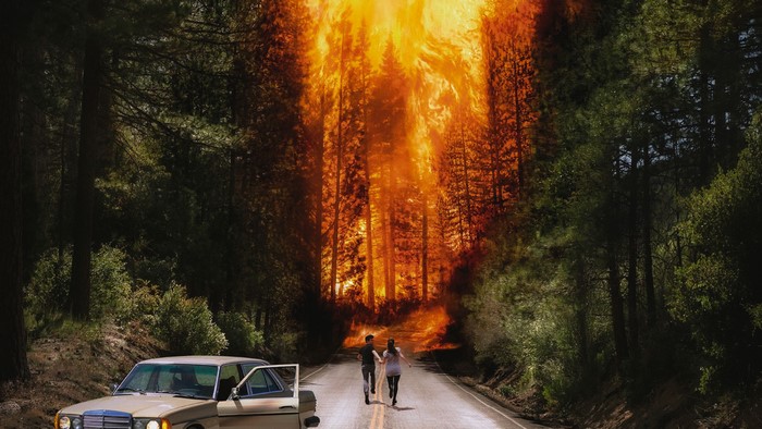 Couple running from wildfire near old car