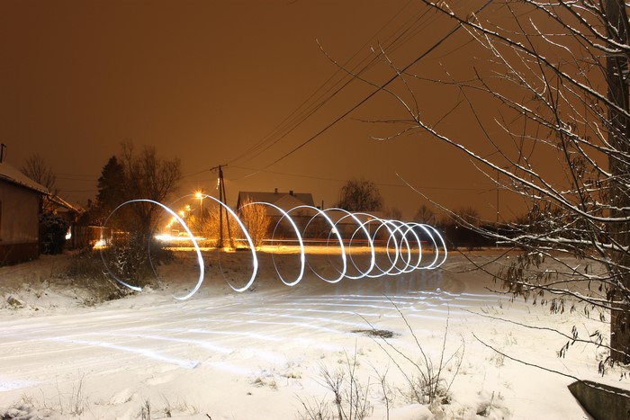 Light painting in a snowy winter landscape at night