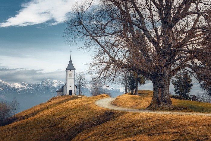 Church on a hill in Slovenia with mountains