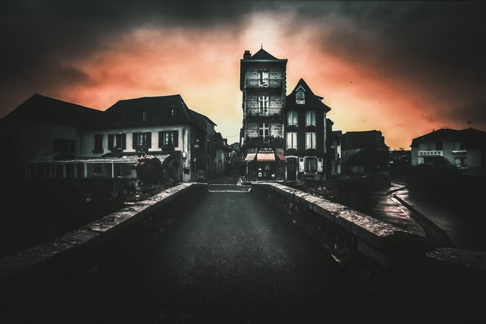 Dark street with old buildings and dramatic sky