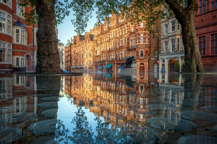 Building reflections in water in London