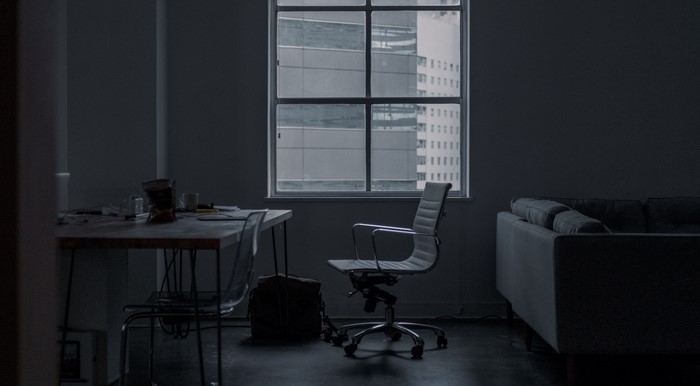 Office interior with desk, chair, and couch