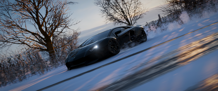 Black Lamborghini Aventador J drifting on a snowy road