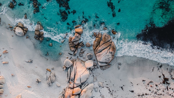 Aerial view of a rocky beach with turquoise water