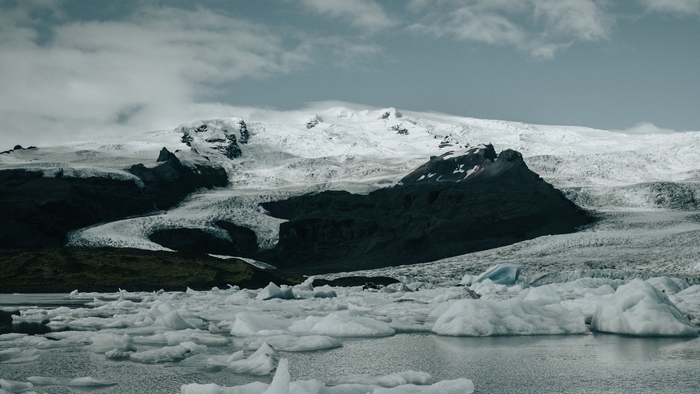 Snow-covered mountain and icebergs on a lake