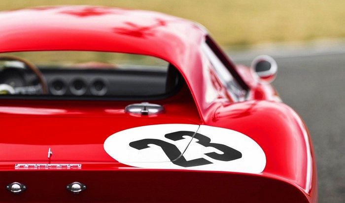 Red Ferrari race car with number 23