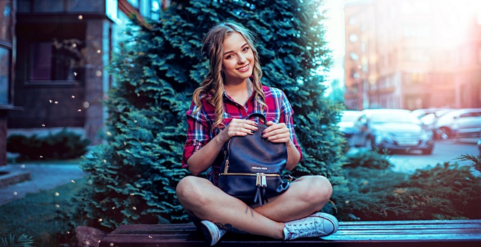 Woman with backpack sitting on a bench