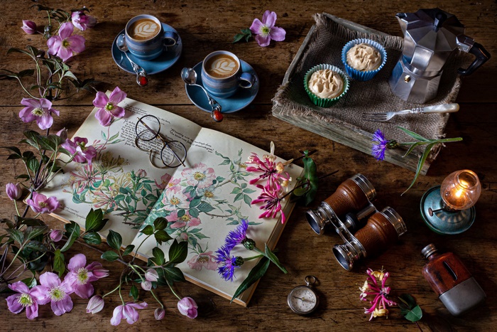 Still life with coffee, flowers, and book