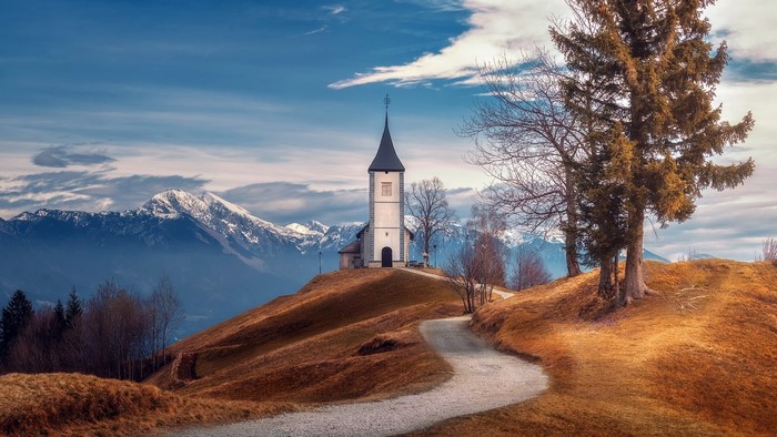 Church on a hill with mountains in the background