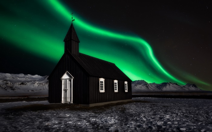 Black church under Aurora Borealis in Iceland