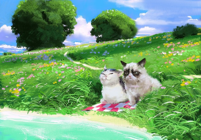 Grumpy Cat and another cat on a picnic blanket in a field