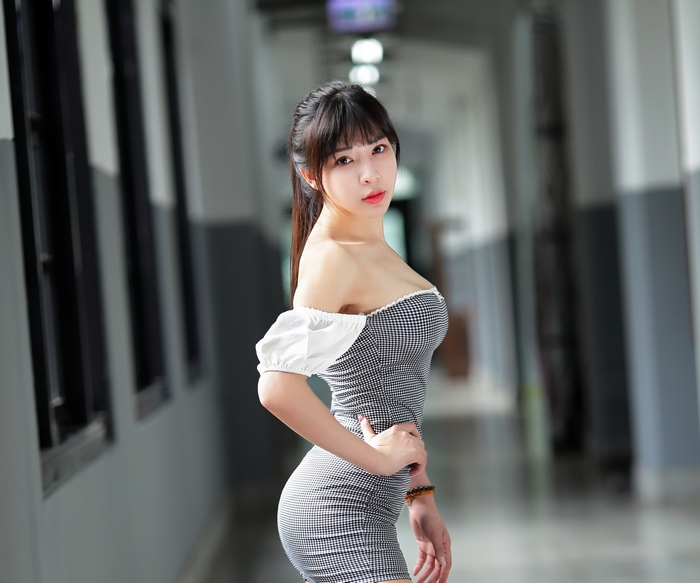 Asian woman in a checkered dress