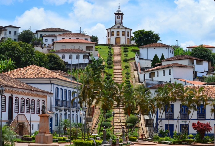 Baroque village church in Minas Gerais, Brazil with palm trees