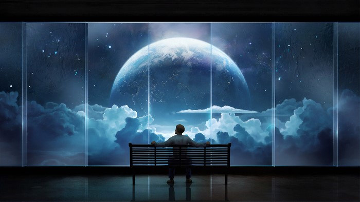 Man sitting on bench looking at planet through window