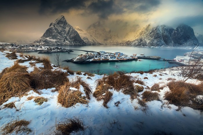 Winter landscape with snow-covered mountains and a village in Norway