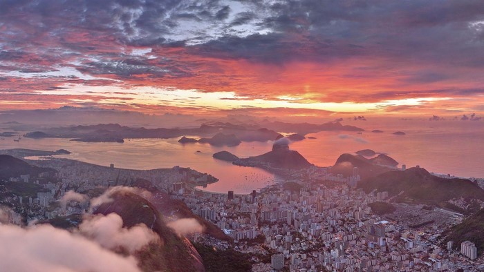 Rio de Janeiro cityscape at sunset with clouds over the sea