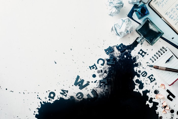 Ink spill with letters and writing tools