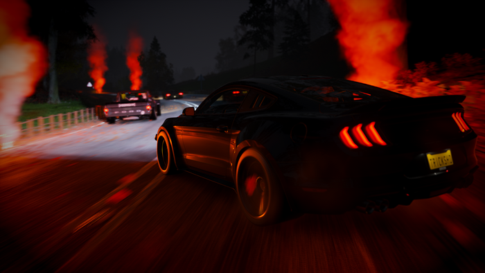 Ford Mustang and pickup trucks racing at night with smoke