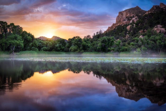 Sunset over a lake with mountain reflection