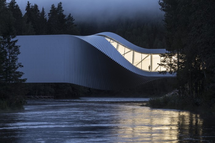 Twist by Bjarke Ingels Group architecture over river