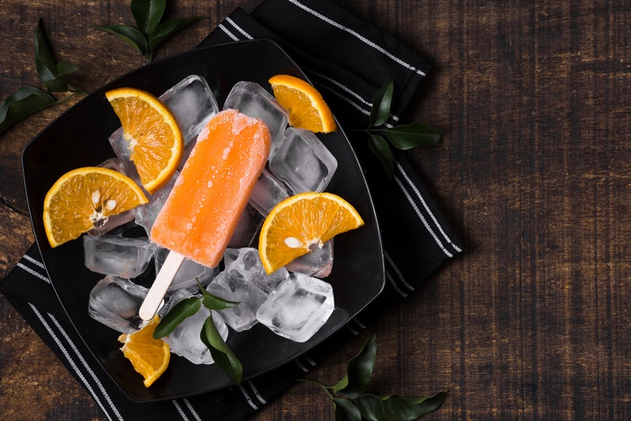 Orange popsicle with ice and orange slices