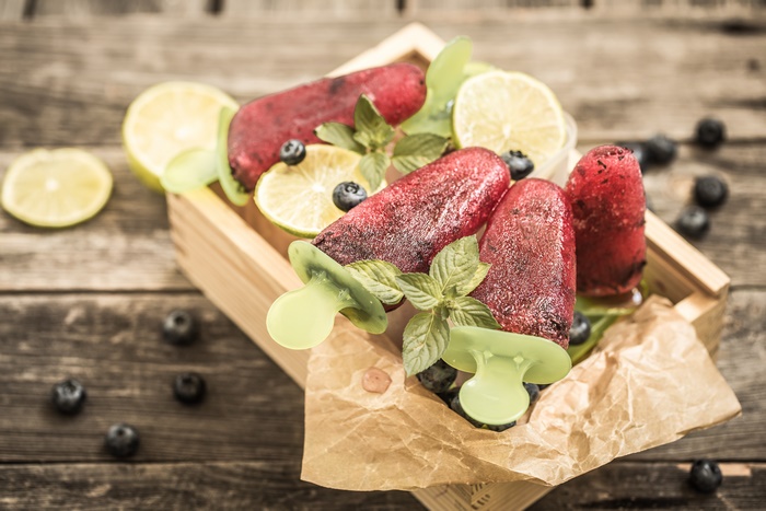 Red berry popsicles with lime and blueberries