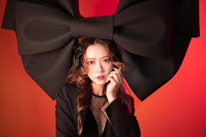 Asian woman with large black bow