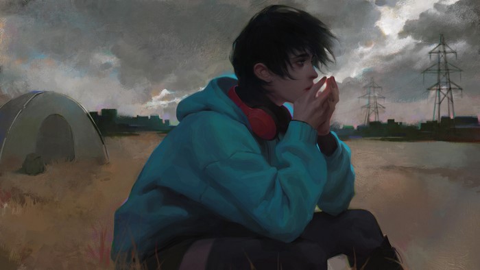Young person in a hoodie with headphones in a desolate landscape