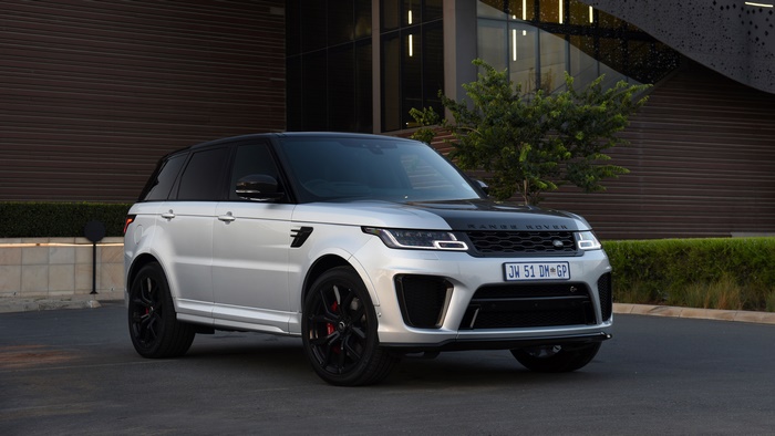 Silver Range Rover Sport SUV parked outside building