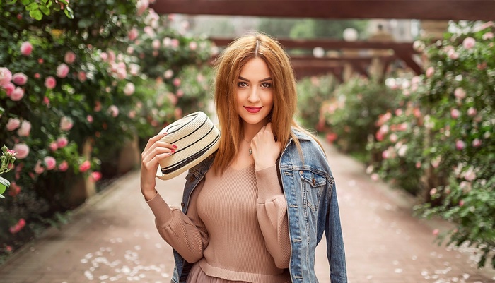 Woman with Red Hair and Hat in Rose Garden