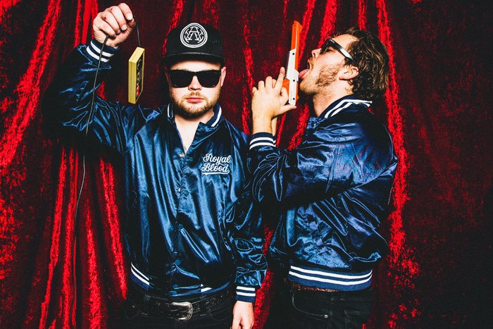 Royal Blood members with toy gun and cassette