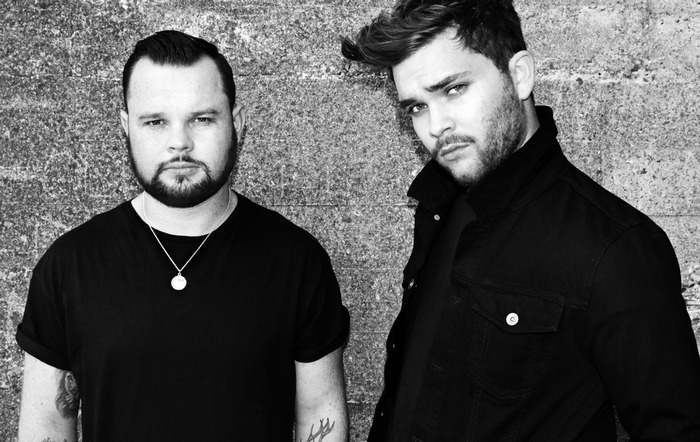 Royal Blood duo posing against a textured wall