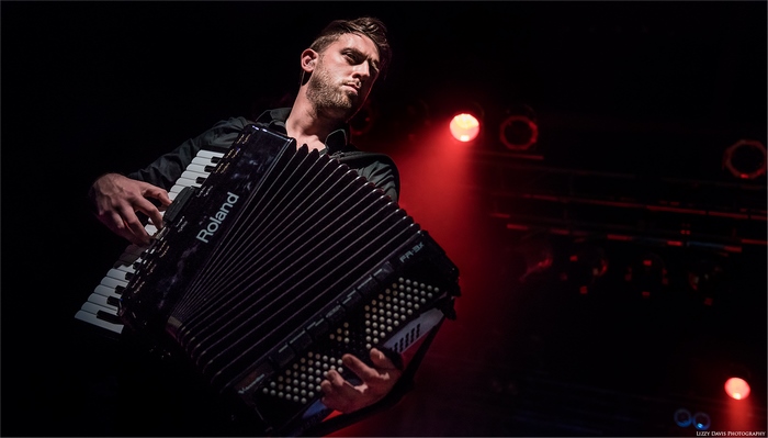 Man playing Roland accordion on stage