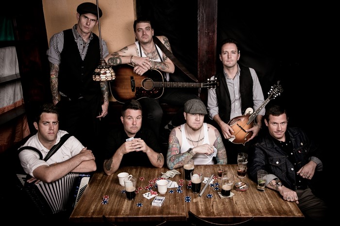 Dropkick Murphys band members with instruments and playing cards