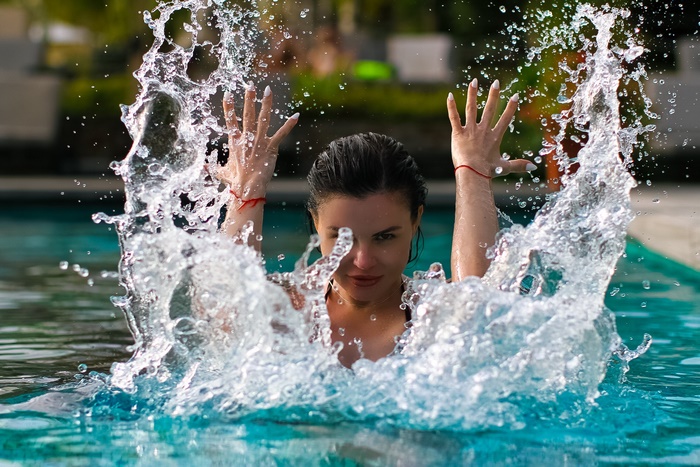 Woman splashing water in a pool