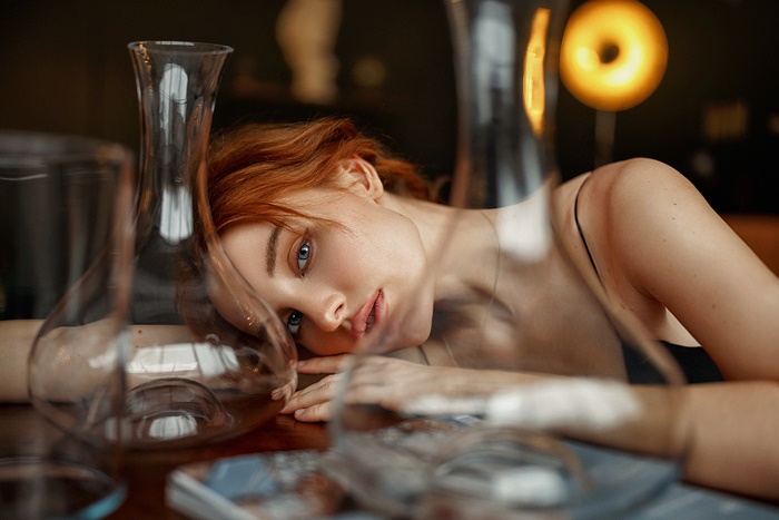 Red-haired woman with blue eyes lying down